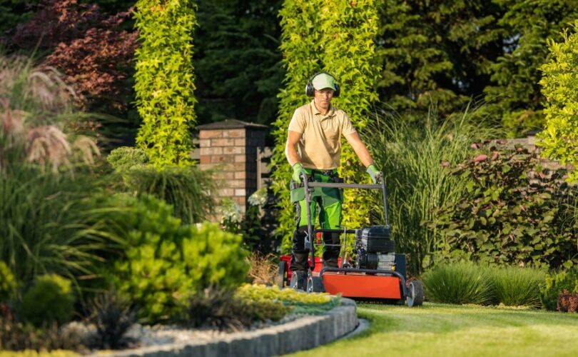 man pushing a mower